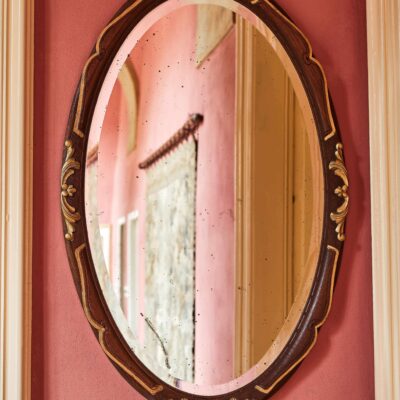 Oval carved mirror with facet